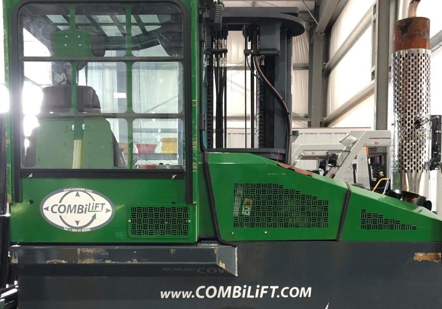 A green and black combilift in a warehouse