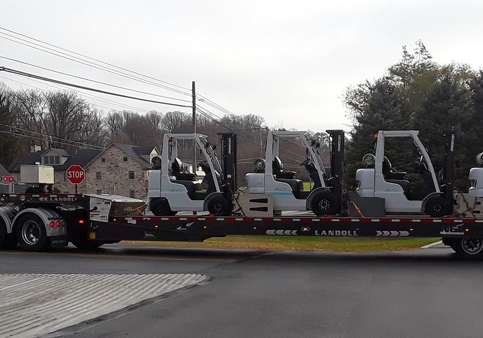 Forklifts on a flatbed truck