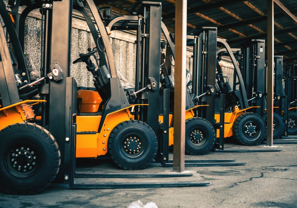 A row of forklifts waiting for forklift maintenance services
